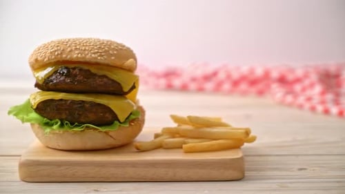 Delicious Double Cheeseburger and Fries on Wooden Board