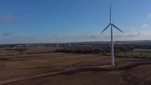 Wind Turbine Generating Power Right in Farm Field, Aerial Drone Push Medium