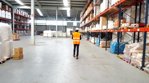 Logistics Operator Walking Through Warehouse