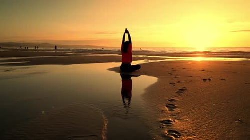 Camera Flying Around Woman Sitting in Meditation Pose Sunset on Vietnam Beach Lotus Position
