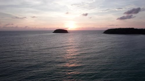 A Tropical Island at Sunset in the Middle of Ocean
