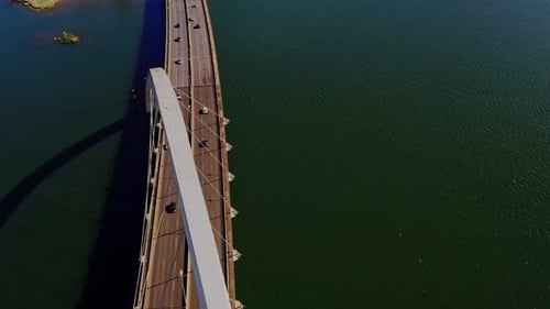Aerial View Of Modern Arch Bridge Crossing Over Deep Blue Waters