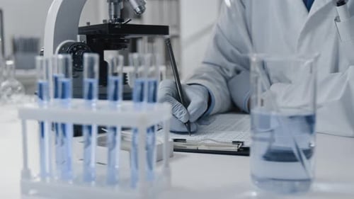 Scientist Taking Notes in a Bright Laboratory