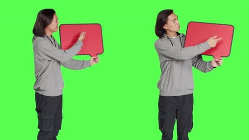 Young Adult Holding a Speech Bubble on Green Screen
