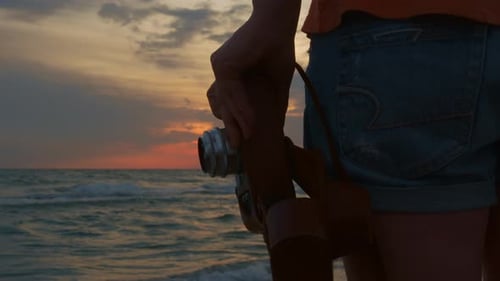 Photographer takes pictures of beautiful seascape at sunset