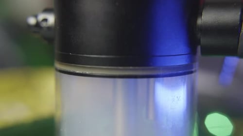 tilt down to reveal the chamber of a water bong for marijuana filling with smoke as the chamber bubb