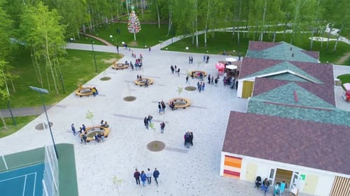 Outdoor Cafe with Guests at Round Tables in Park