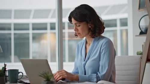 Busy Entrepreneur Checking Papers After Typing Laptop in Modern Office Closeup