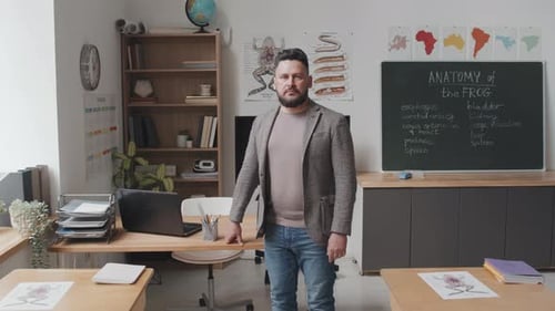 Adult Male Teacher Standing in Classroom