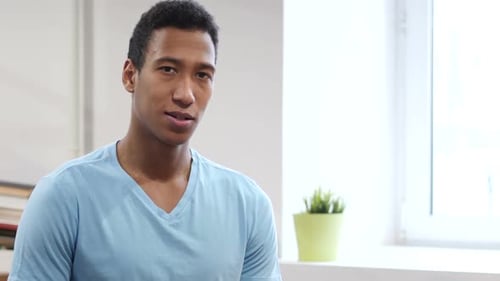 Man Gesturing Okay Sign Smiling Indoors