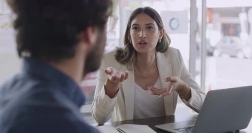 Woman Talking to Colleague During Office Meeting
