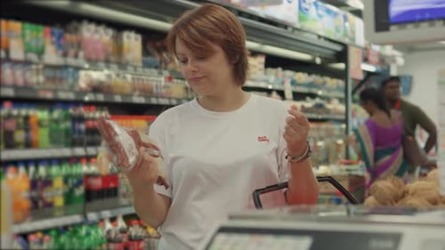 Young Woman Choosing Sugar in the Supermarket Close Up