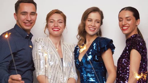 Smiling Friends Celebrate Together Holding Sparklers