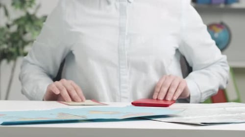 Passport and Plane Tickets Held Up to Camera