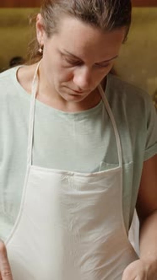 Vertical video. Mixing Ingredients in a Bowl with a Whisk, Combining Flour and Other Components for