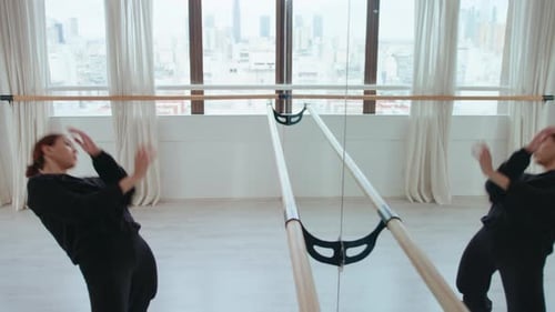 Professional Female Dancer Improvising in front of Mirror in Studio