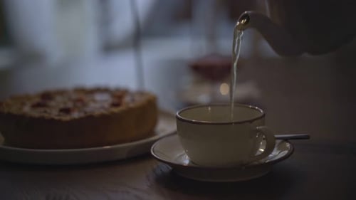 Pouring Tea Next to a Pie