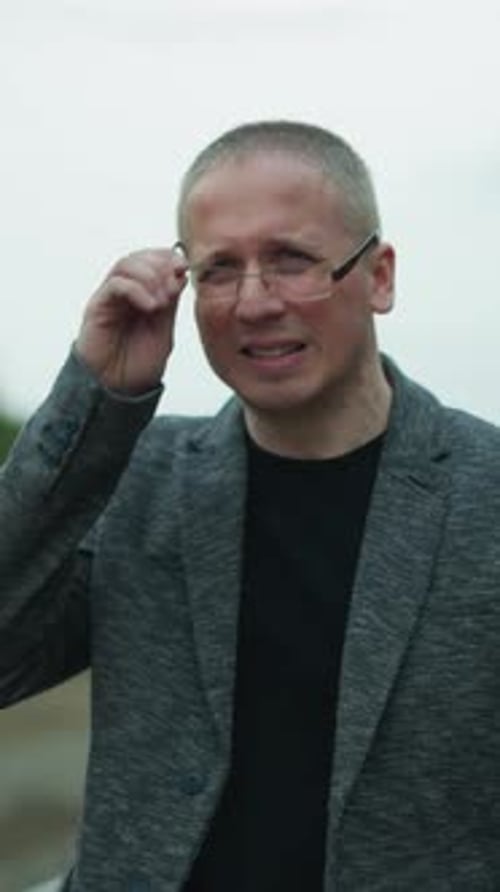 Man Wearing Eyeglasses Outside in Natural Setting