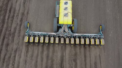 Blue tractor OA working on the field in Ukraine