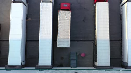 Aerial Shot of Truck with Attached Semi Trailer Leaving Industrial Warehouse Storage Building Loadin