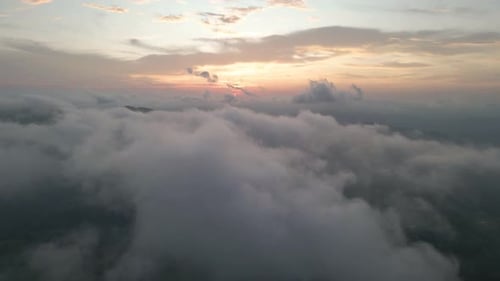 sunset through the clouds. Flying heavenly beautiful sunny cloudscape. Amazing golden fluffy on the