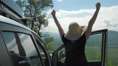 Female Traveler Standing Near Car Watching Mountain View While Travel Road Trip
