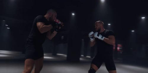 Men Boxing and Training in Dark Boxing Gym
