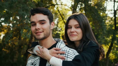Smiling Couple Embraces in Green Park Setting