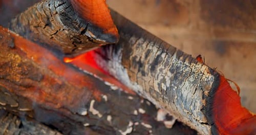 Red Hot Logs in Wood Burning Fireplace, Close Up