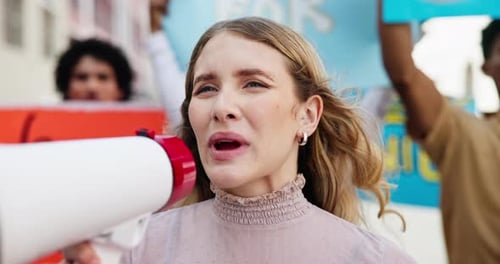 Young Woman Speaks Into Megaphone at Protest