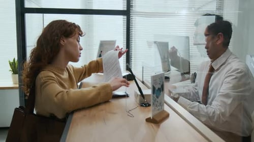 Woman Signing Documents in Bank Office