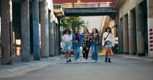 Five Friends Walk Down Urban Alleyway