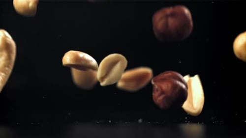 A Variety of Nuts Fall on the Table Filmed on a Highspeed Camera at 1000 Fps