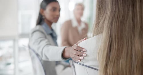 Supportive Hand on Shoulder in Office Meeting