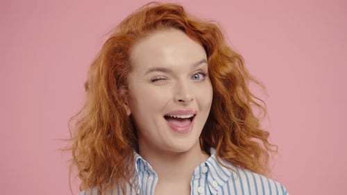 Cheerful Young Adult Winking and Smiling at Camera