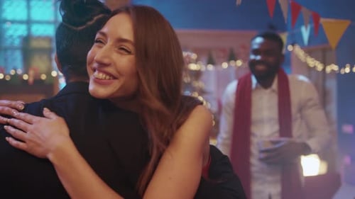 Smiling Friends Exchanging Christmas Gifts at Home