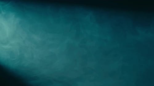 Abstract Background of Chaotically Blending Puffs of Blue Smoke on a Black Background Realistic Fog