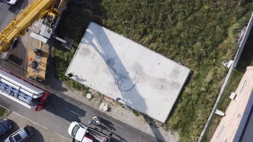 Los trabajadores se preparan alrededor de los cimientos de plataformas de concreto para la construcción.