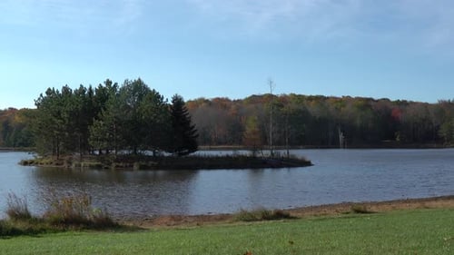 An island in the middle of a lake in the wilderness.