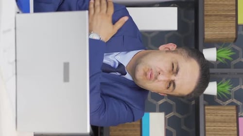 Businessman Massaging Neck with Pain in Office