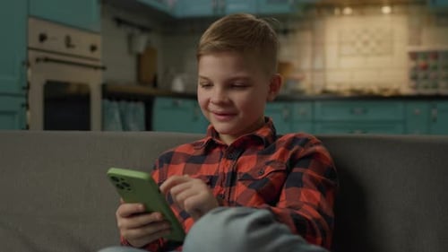 Boy with blond hair scrolling on a smartphone