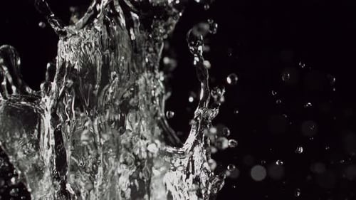 Water Splashing Against Dark Background in Slow Motion