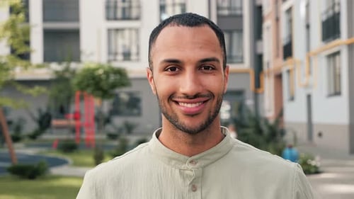 Smiling Man Close Up In City Park