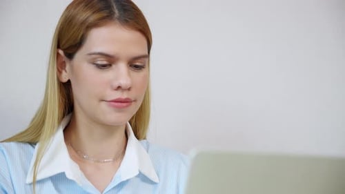 Happiness young businesswoman using laptop computer on desk in living room at home office.