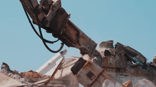 Excavator Hydraulic Hammer Breaking Concrete Structure During Demolition Close Up