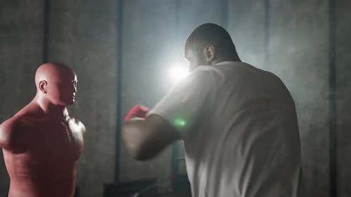 Boxer Training Hitting Punching Bag African American Focused Sportsman Practicing Punches in Gym