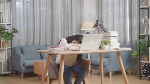 Bored Teenager Yawning And Sleep At Home While Doing Home Work On Laptop, Child Learning Online