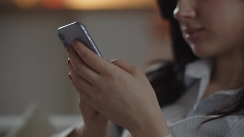Woman Using Cell Phone in Home Setting
