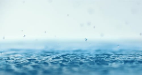 Rain water drops falling in super slow motion.