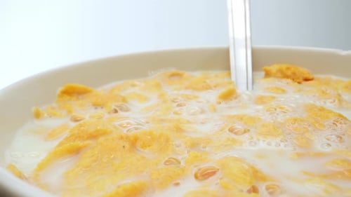 Bowl of Corn Flakes Cereal with Milk